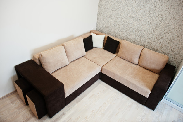 bicolor-cofee-corner-sofa-bed-light-room_151355-1800
