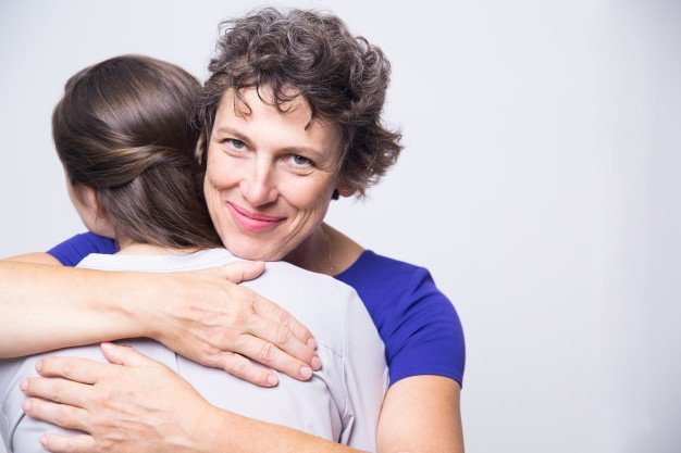 happy-senior-woman-embracing-young-adult-daughter_1262-2132